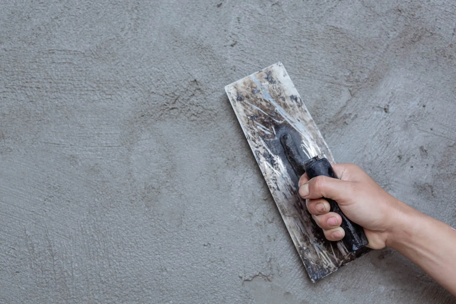 Artisan peintre travaillant sur la façade d’un bâtiment professionnel à Belfort avec échafaudage