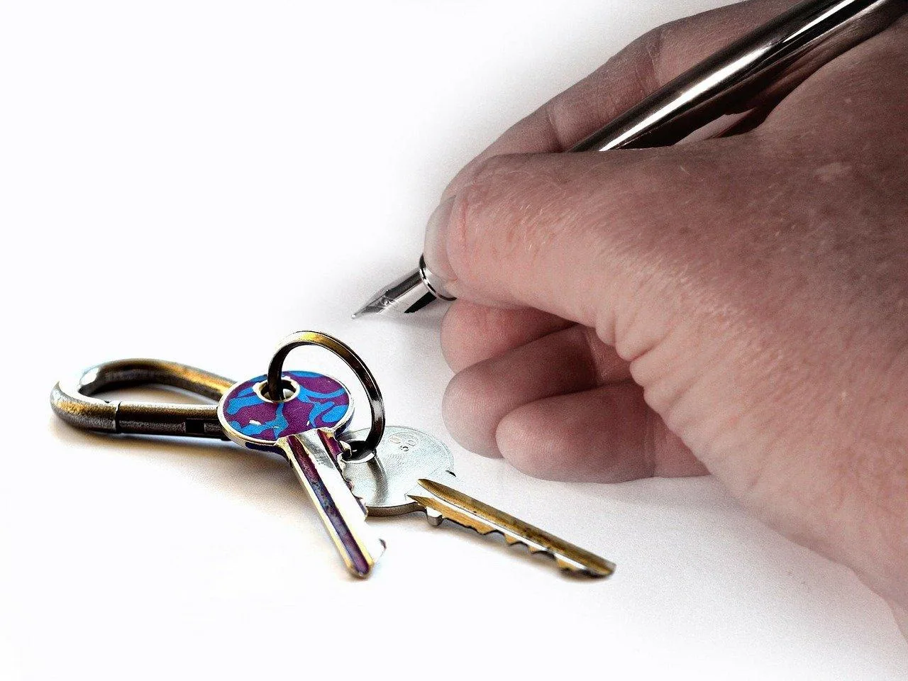 Un commerçant signe un contrat de location dans un local commercial vide avec des plans et des clés posés sur la table