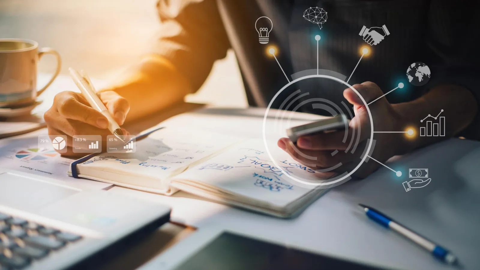 Entrepreneur solo préparant un business plan avec ordinateur, graphiques financiers, tableau de prévisions et documents de travail